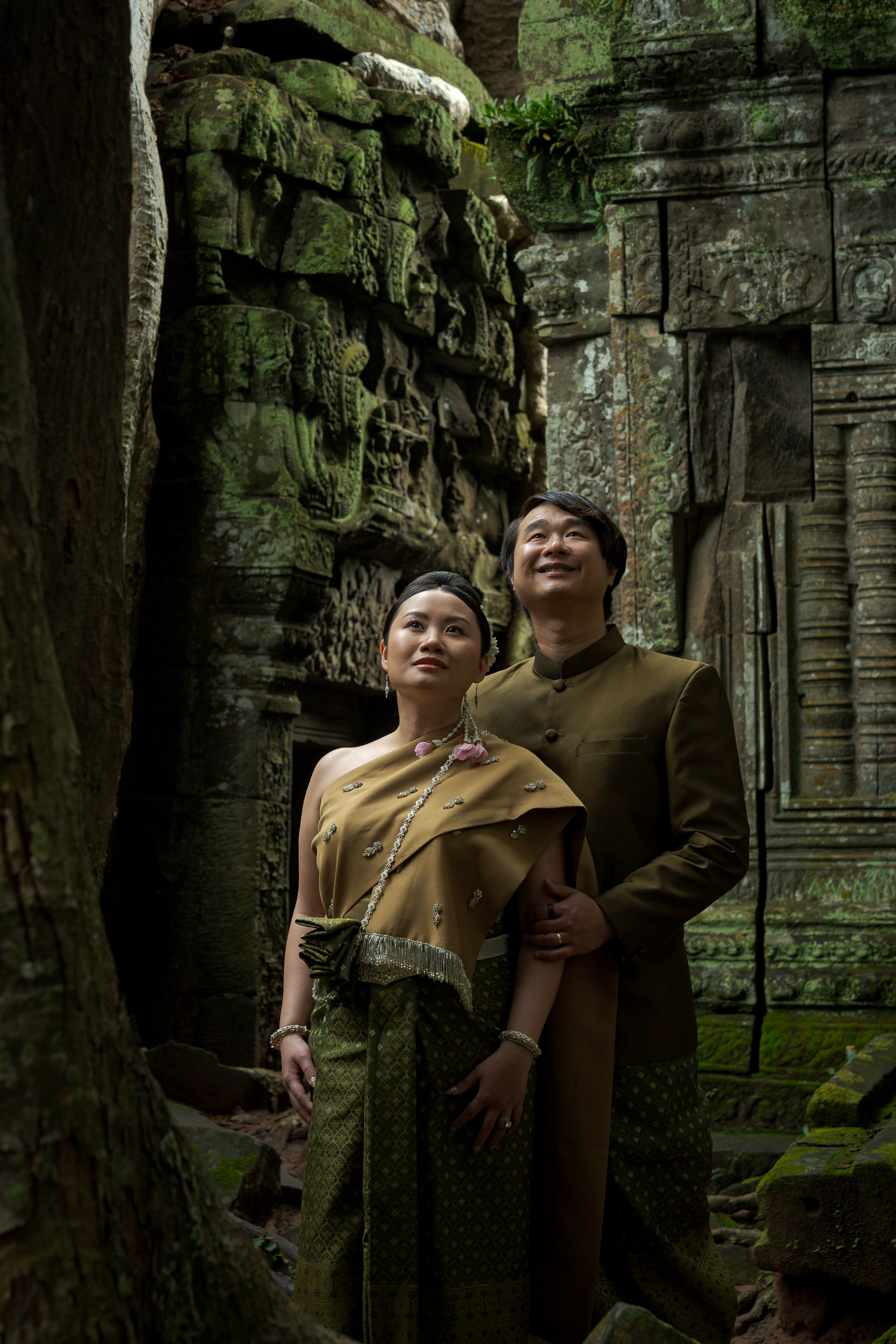 Couple at Ta Prohm Temple in Angkor on a traditional clothes photoshoot captured by Siem Reap Photographer
