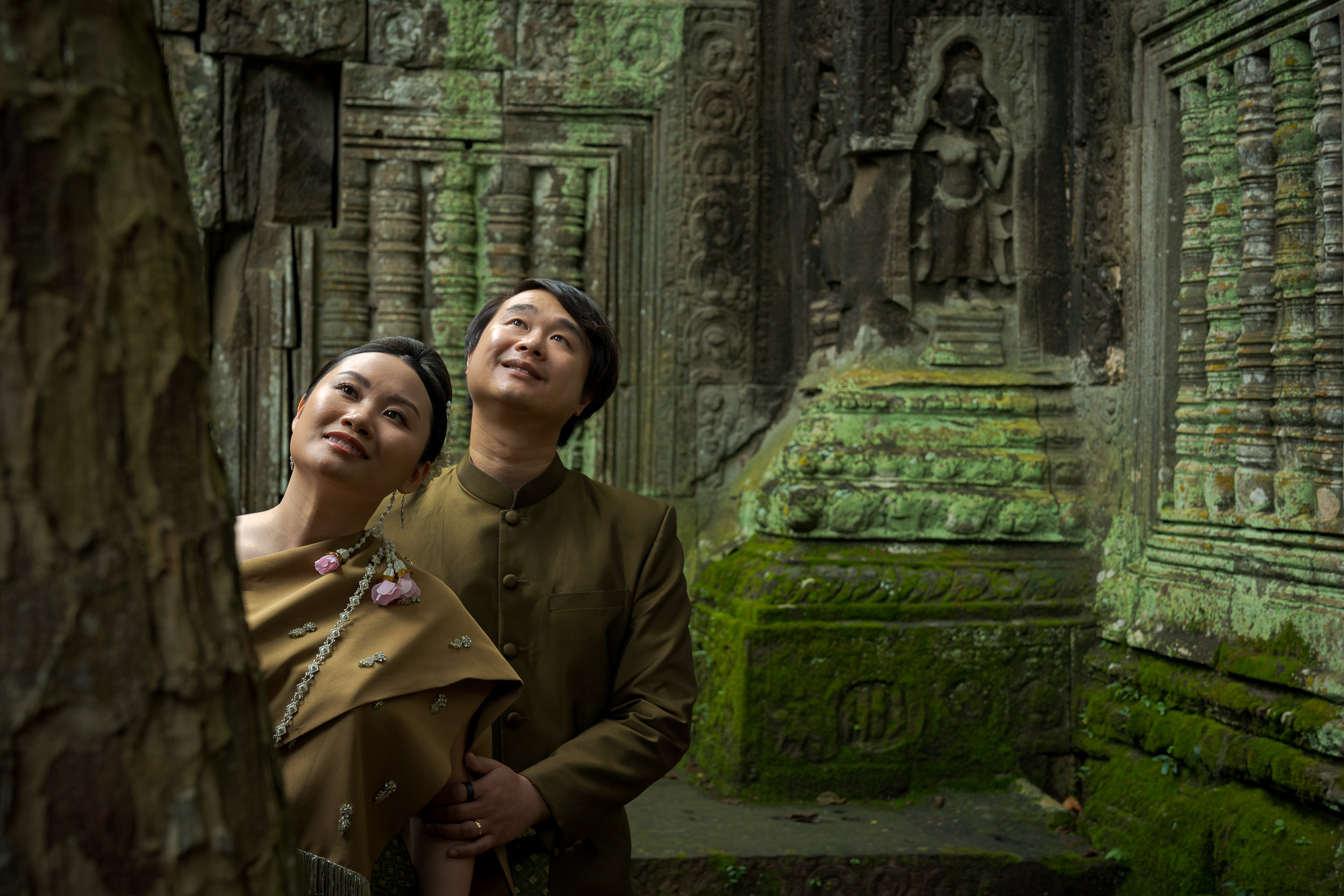 Couple at Ta Prohm Temple in Angkor on a traditional clothes photoshoot captured by Siem Reap Photographer