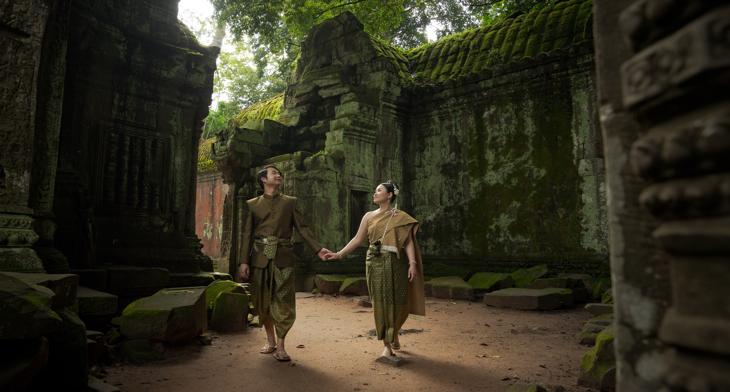 Couple at Ta Prohm Temple in Angkor on a traditional clothes photoshoot captured by Siem Reap Photographer