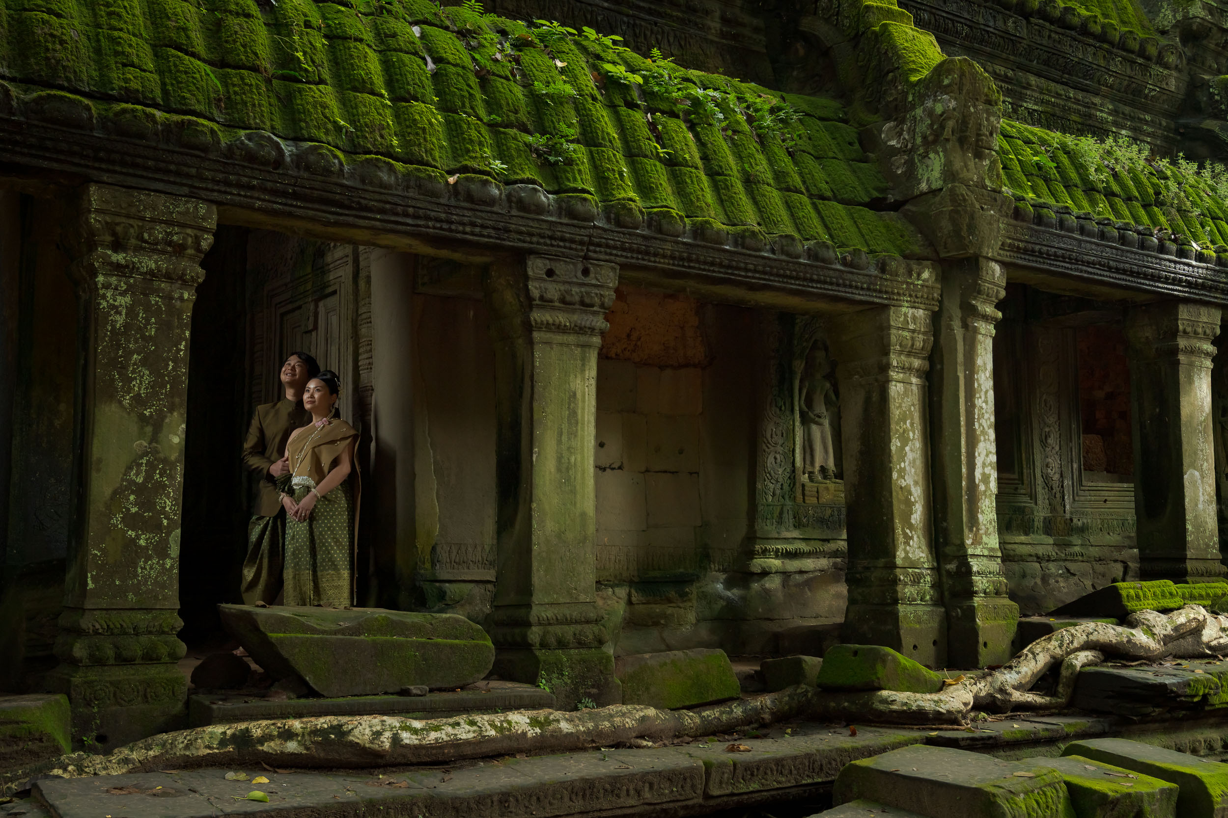 Couple at Ta Prohm Temple in Angkor on a traditional clothes photoshoot captured by Siem Reap Photographer