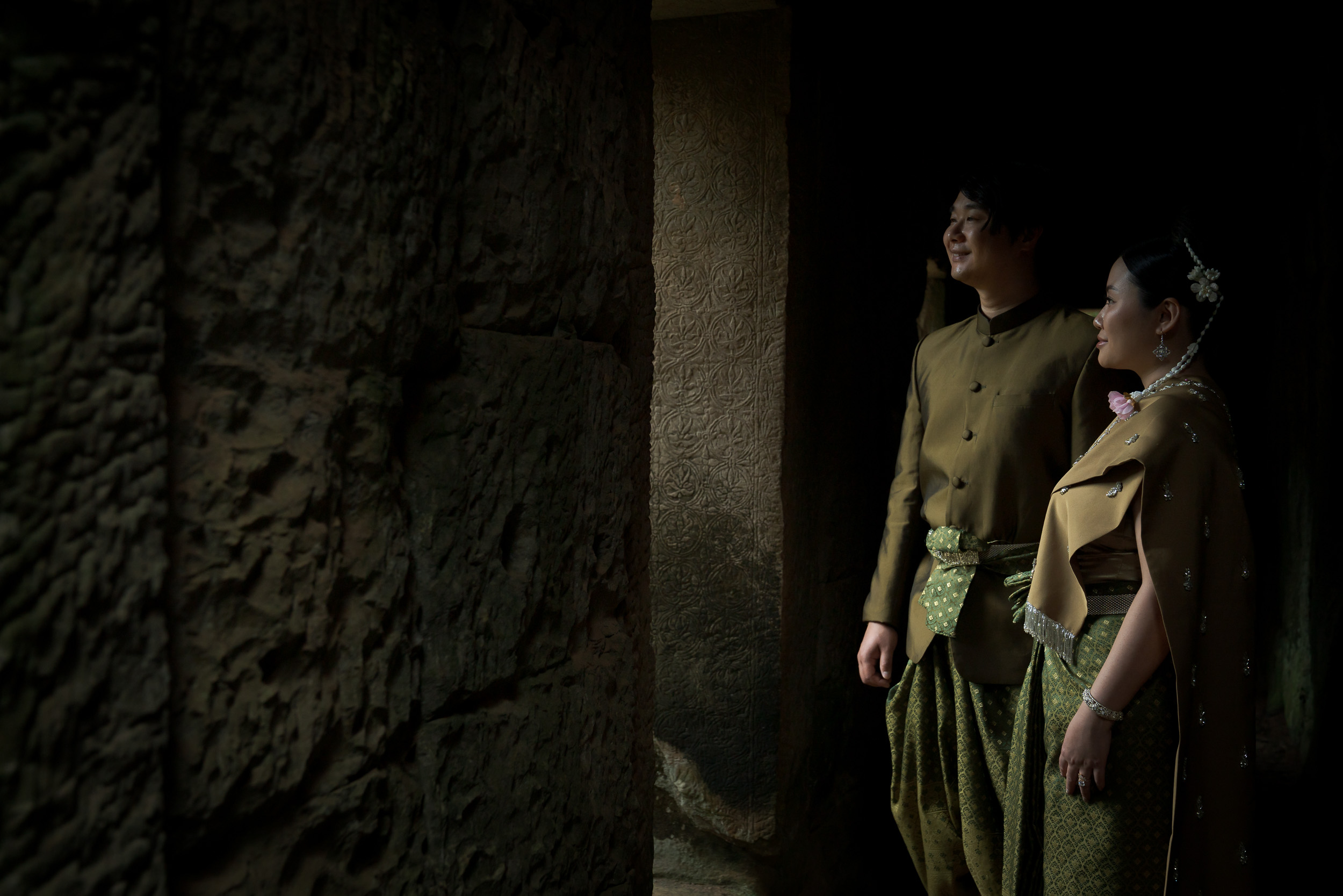 Couple at Ta Prohm Temple in Angkor on a traditional clothes photoshoot captured by Siem Reap Photographer