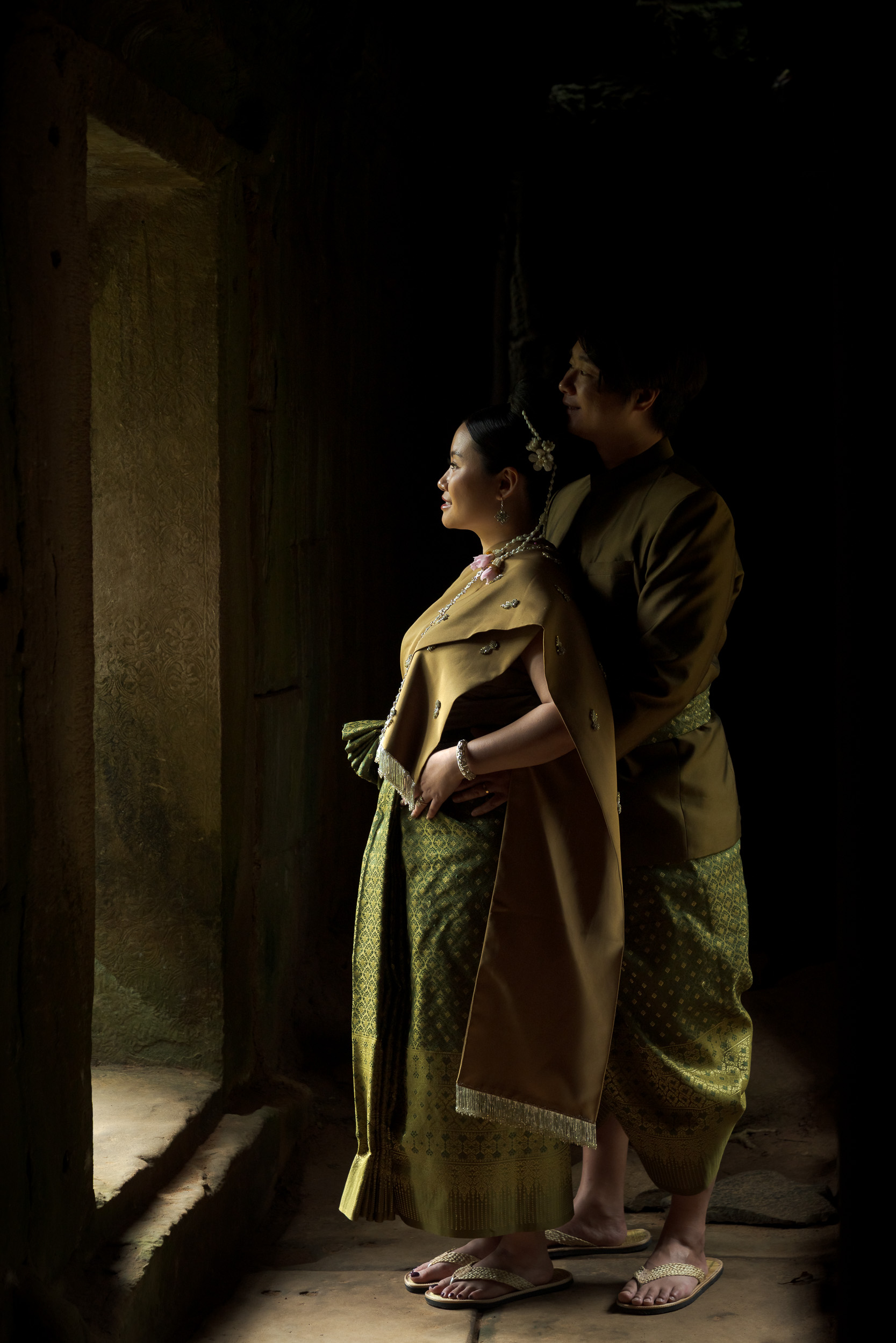 Couple at Ta Prohm Temple in Angkor on a traditional clothes photoshoot captured by Siem Reap Photographer