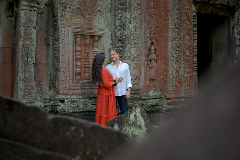 couple at ta prohm temple, siem reap, lady wearing a bold red dress