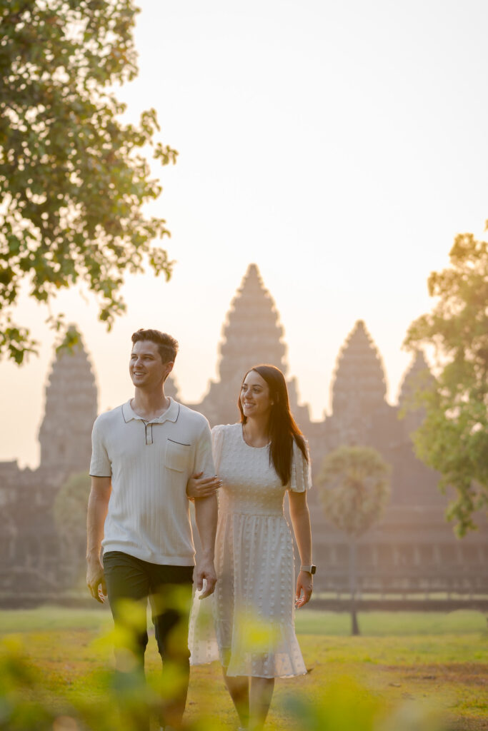 couple walking with Angkor Wat sunrise background Cambodia