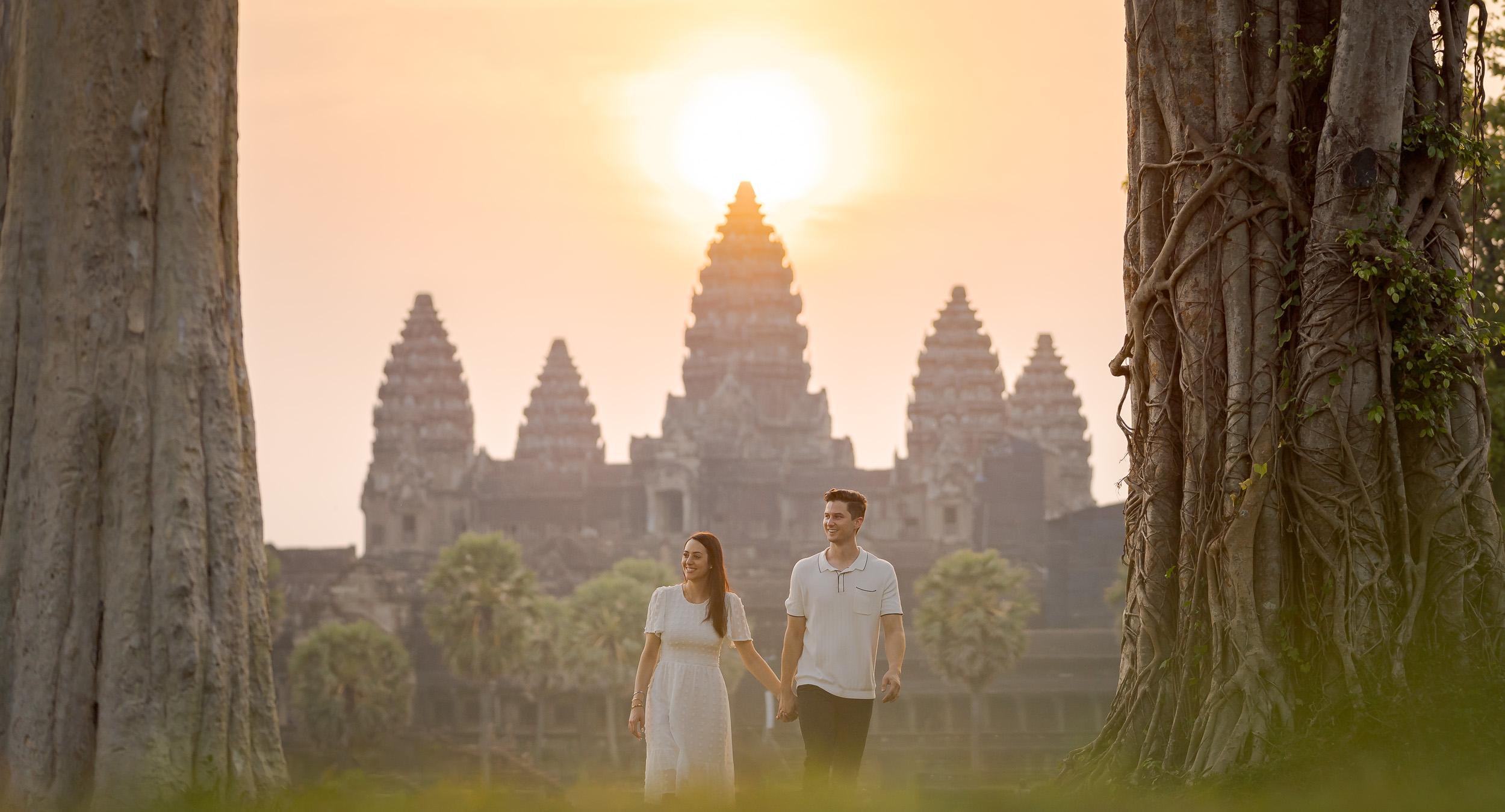 couple walking with Angkor Wat sunrise background Cambodia