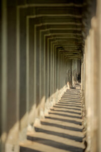 Angkor Wat corridor with repeating stone columns and leading lines