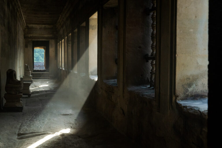 Angkor Wat corridor with light rays and stone columns for photography