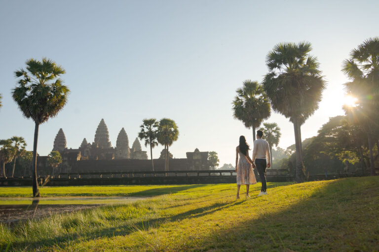 Couple walking at sunrise Angkor Wat Siem Reap photographer golden light session