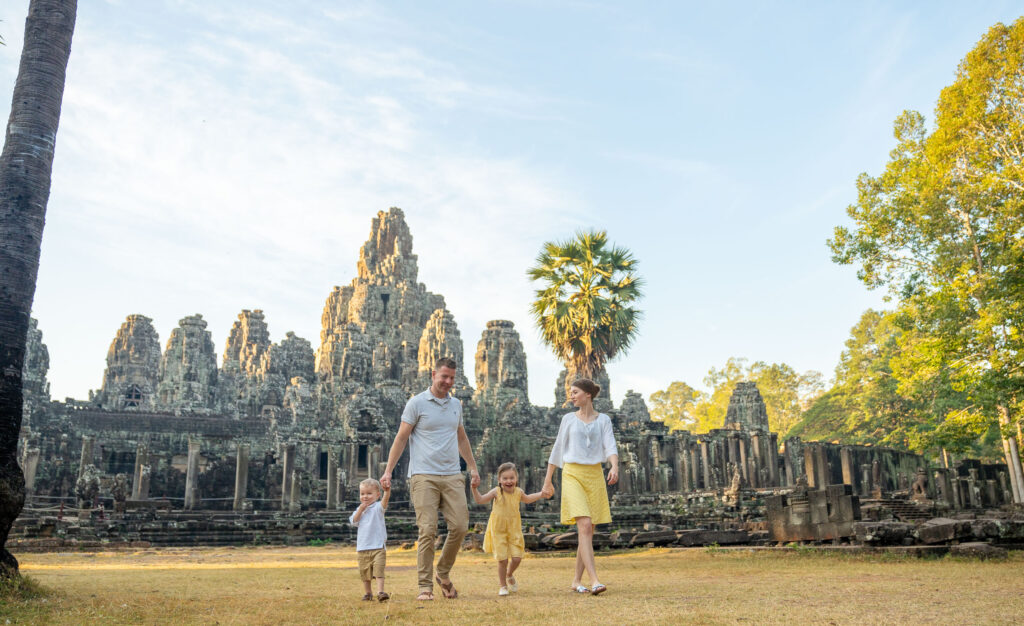family on a photoshoot with siem reap photographer at bayon temple, siem reap, cambodia