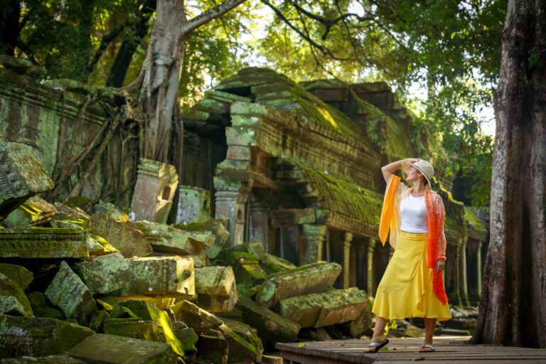 lady at ta prohm temple, siem reap, wearing bold colors on a photoshoot