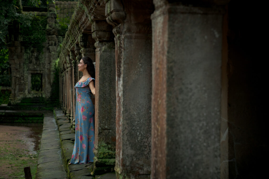 Atmospheric portrait inside Ta Prohm Temple with ancient stone corridors and soft natural light