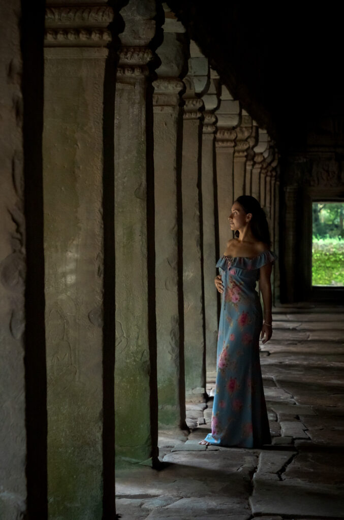 Atmospheric portrait inside Ta Prohm Temple with ancient stone corridors and soft natural light