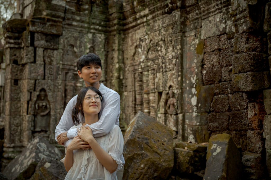 Newly engaged couple together in the forest at Ta Nei Temple